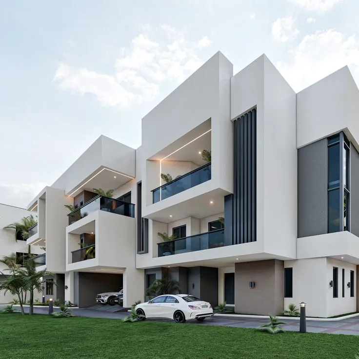 Modern white townhouses with a car parked outside